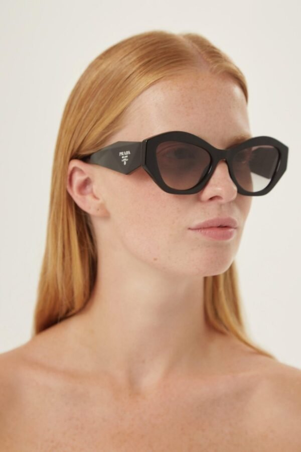 Prada oval black sunglasses featuring iconic logo - Lux Studios
