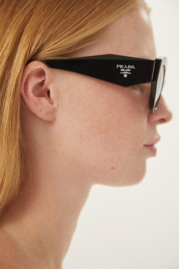 Prada oval black sunglasses featuring iconic logo - Lux Studios