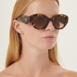 Prada oval sunglasses featuring iconic logo - Lux Studios
