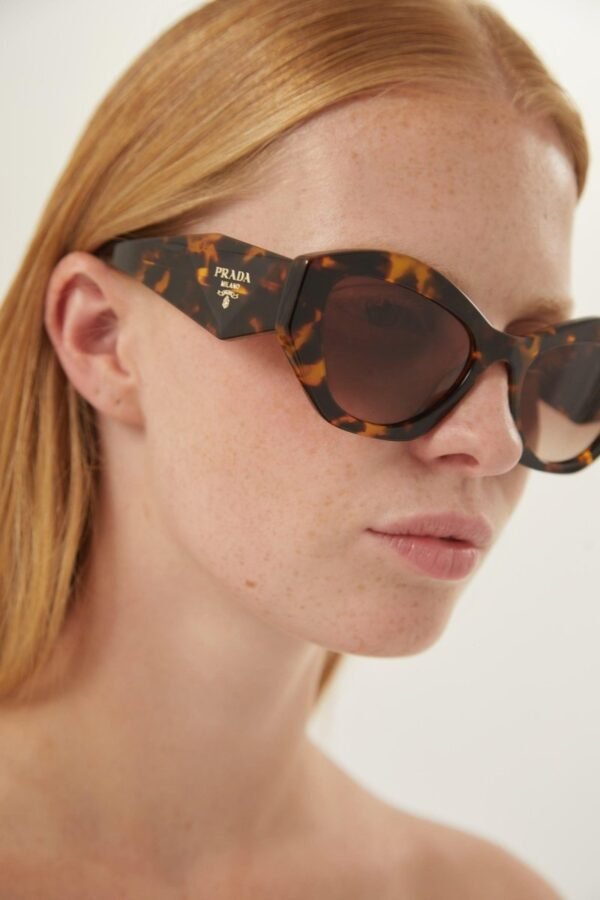 Prada oval sunglasses featuring iconic logo - Lux Studios